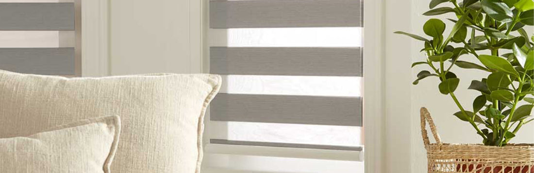 Stylish recess fitting blinds in a cozy living room with a plant and soft sofa.