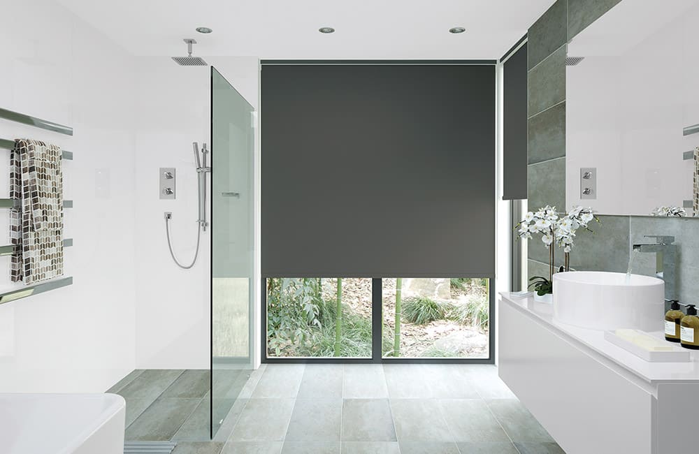Modern bathroom featuring sleek black roller blinds and a glass shower for a stylish, clean look.