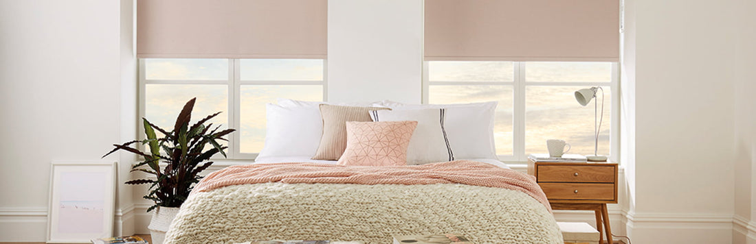 Cozy bedroom featuring stylish blackout blinds, plush bedding, and decorative pillows.