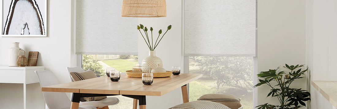 Modern dining area featuring roller blinds, a wooden table, and stylish decor elements.