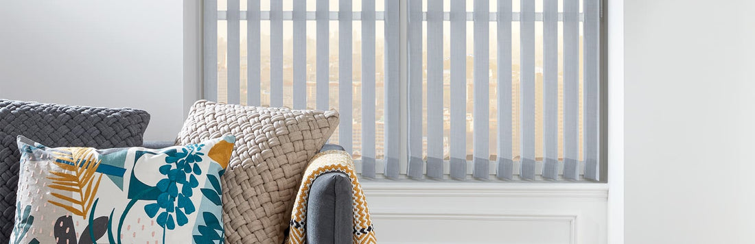 Stylish vertical blinds in a modern living room with decorative pillows.