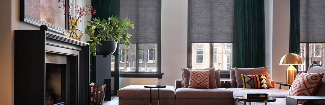 Modern living room featuring smart blinds, green curtains, and stylish furniture for a contemporary aesthetic.