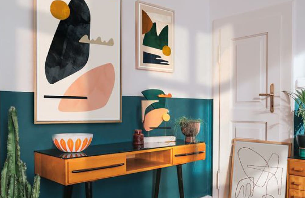 A stylish living room featuring colorful abstract art, a wooden console table, and vibrant decor elements.