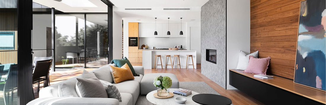Modern kitchen with stylish blinds, comfortable seating area, and sleek wooden accents in an open-plan design.
