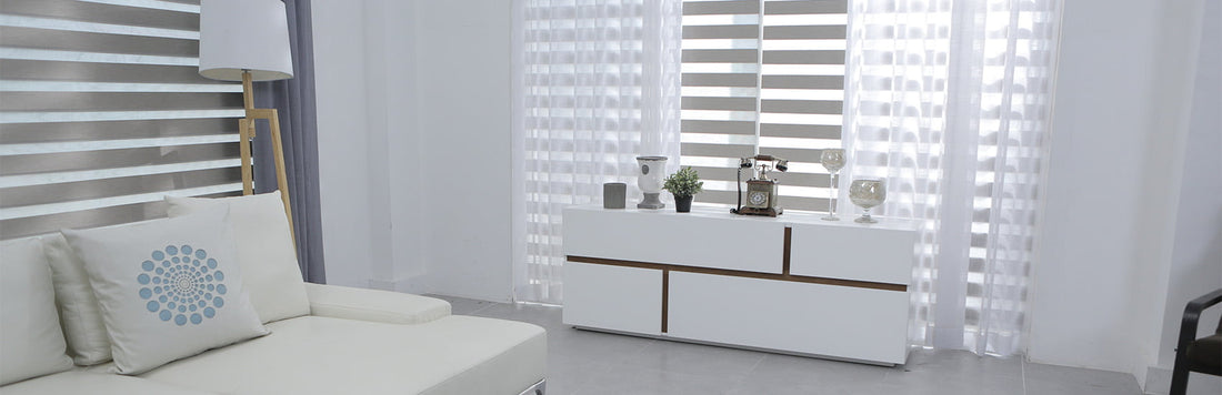 Stylish living room featuring sheer curtains paired with blinds and modern furniture.