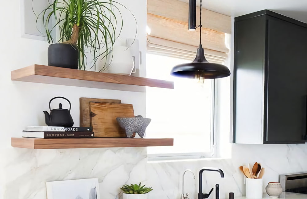 Stylish open kitchen shelves with plants, decorative items, and sleek modern decor in a small space.
